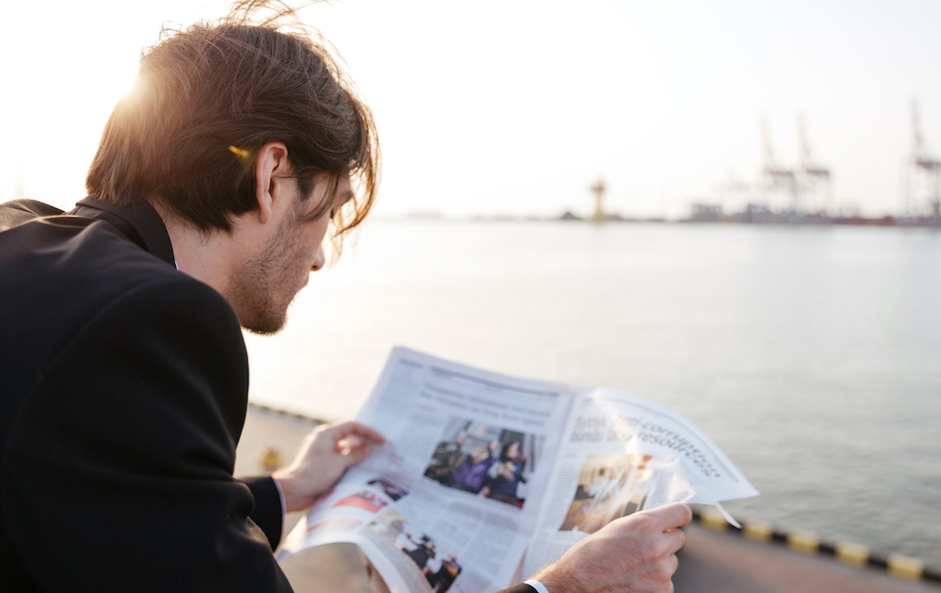 Successful businessman reading newspaper