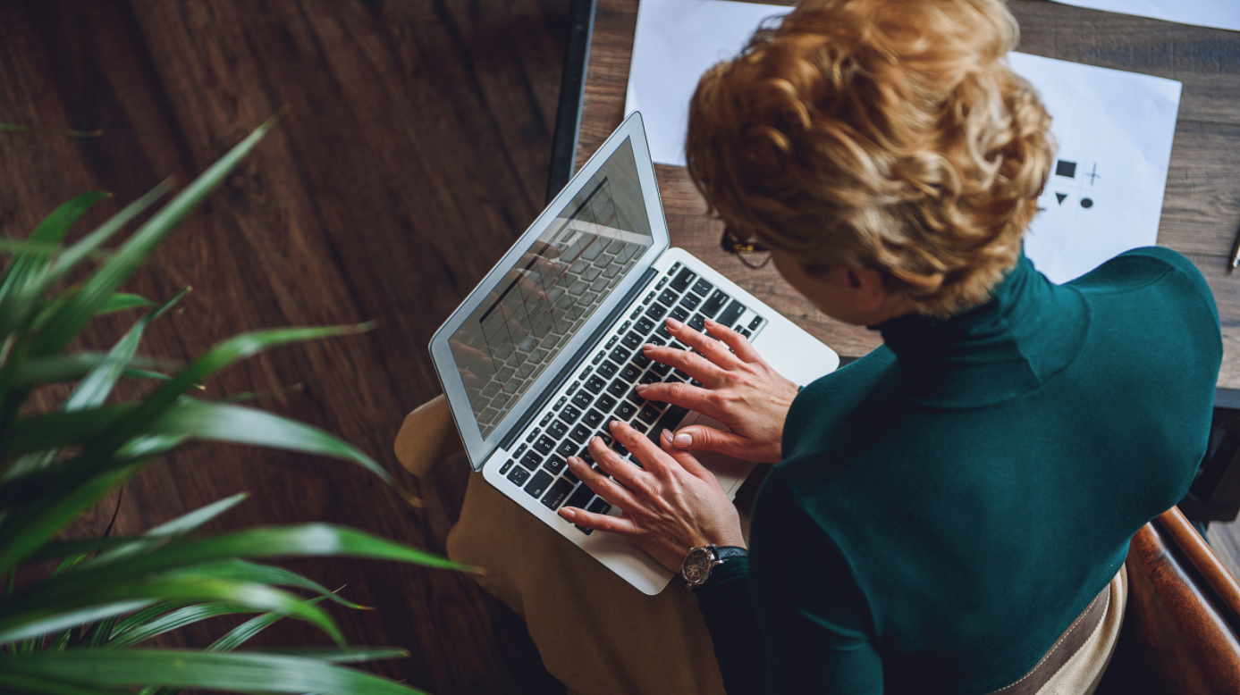 Canva Stock.woman.green.sweater.laptop PM